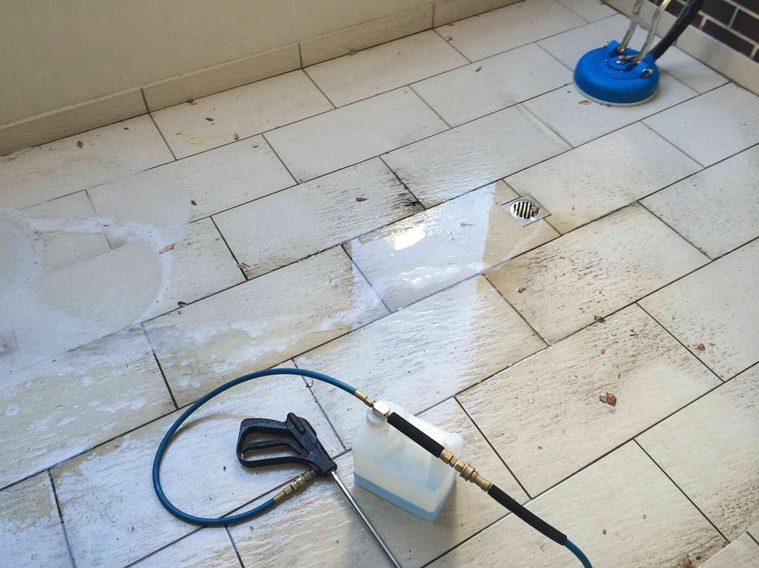 Tile floor part cleaned showing the original grout colour returning